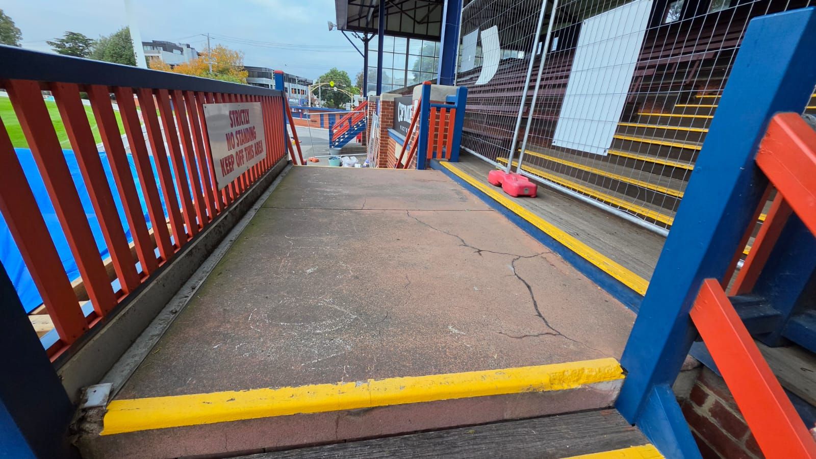 Cracked concrete grandstand ramp at ETU Stadium before resurfacing