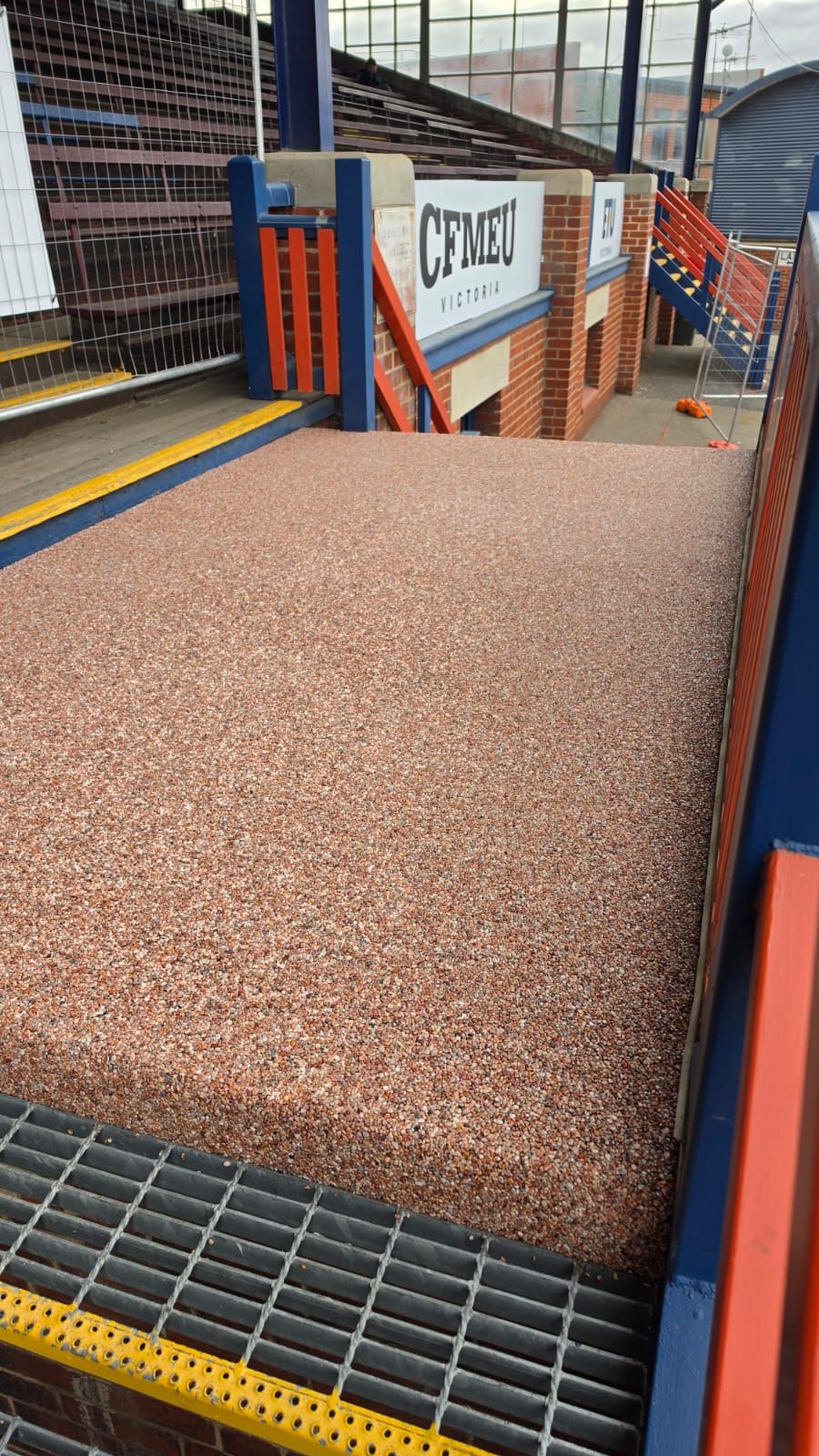 Completed resin bound walkway between the grandstand seating at ETU Stadium