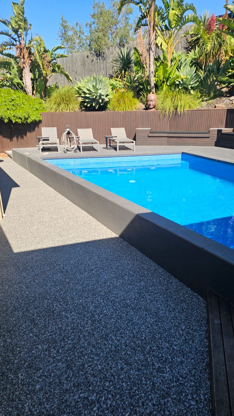 Completed resin bound pool surround wrapping the full length of the pool