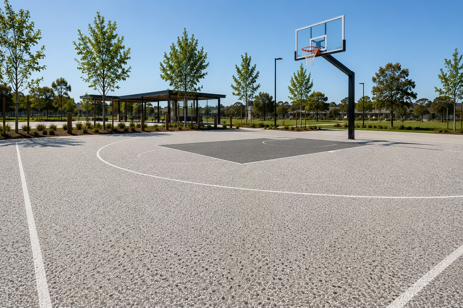 Resin bound surfacing on a public basketball court and park pathway