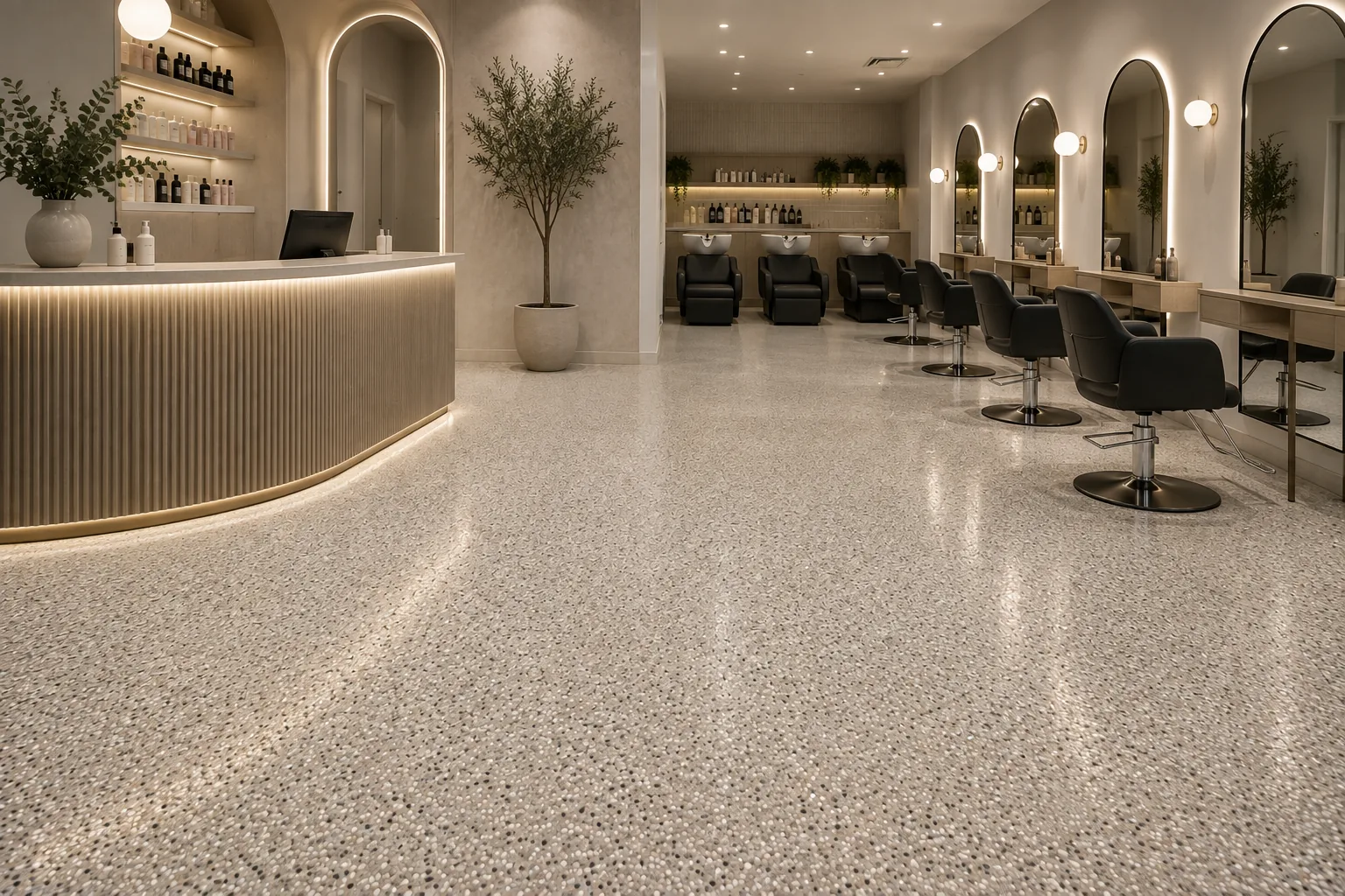 Seamless stone floor through a retail fitout, running from the reception counter through the salon floor
